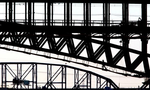 Construction worker climbs beneath Eads Bridge in 2012